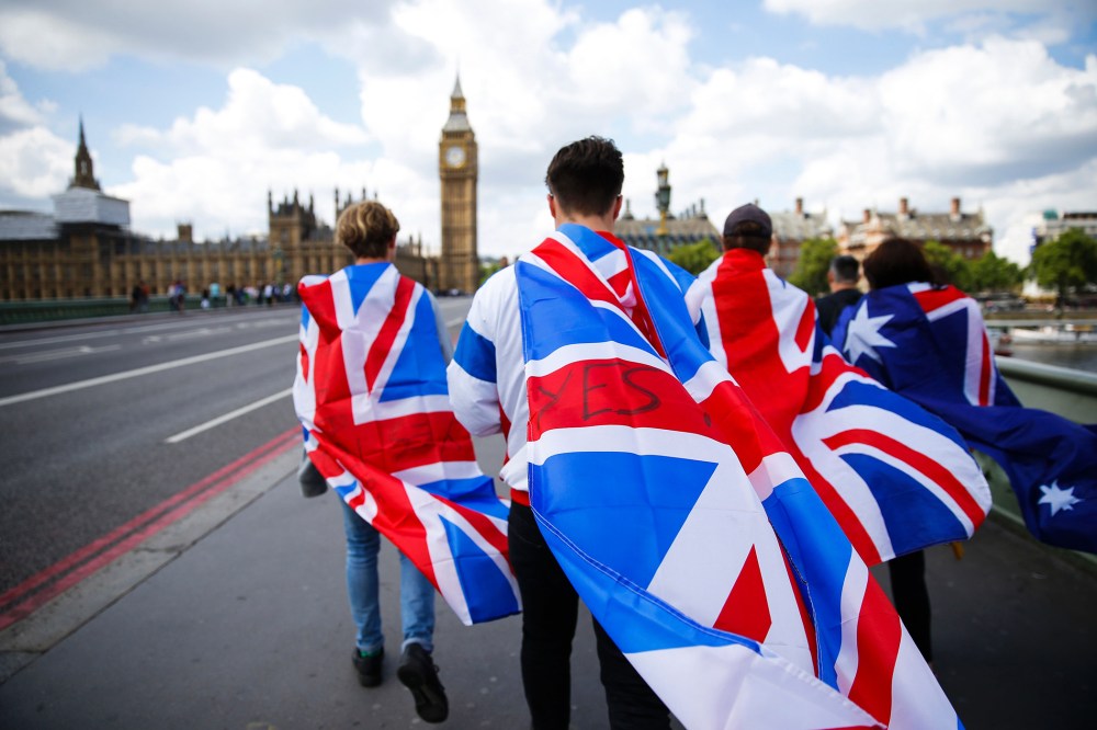 People walk over Westminster Bridge towards the Queen Elizabeth Tower (Big Ben) and The Houses of Parliament wrapped in Union flags on June 26, 2016 in central London. (Photo by Odd Andersen/AFP/Getty)