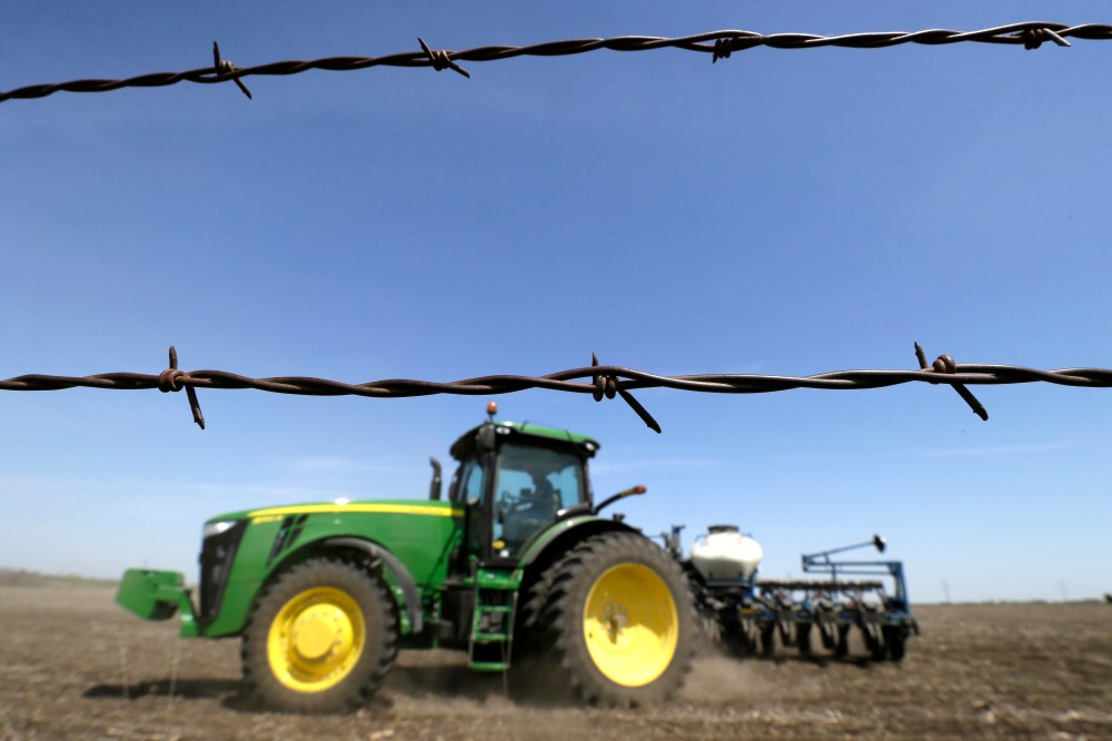 A farmer plants corn in a field near De Soto, Iowa on May 5, 2014.