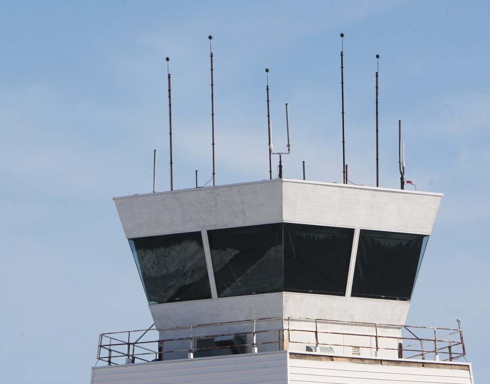 A twin engine airplane flies by the tower at St. Louis Regional Airport in Bethalto, Ill., Monday Feb. 25, 2013, before circling to land. The airport is one of 100 airports nationwide with less than 150,000 annual flights that will likely loose their...