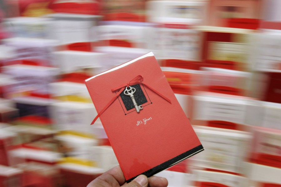A Hallmark Gold Crown valentines card is held for a photograph at Audrey's Hallmark in Lawrence, Kan., Tuesday, Feb. 7, 2006.