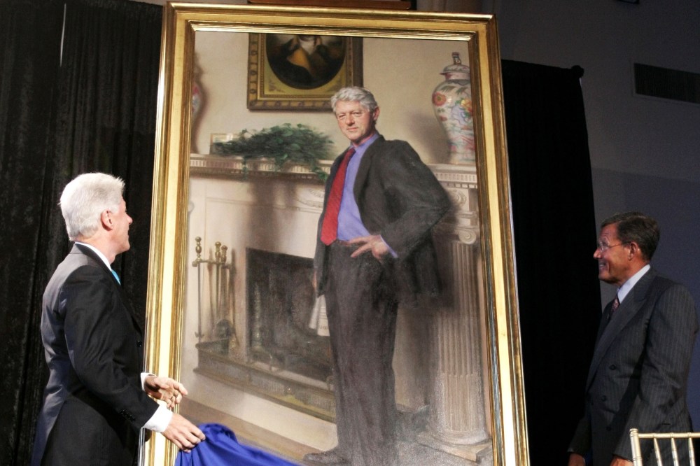 Former President Bill Clinton, left, looks up at his portrait after Lawrence M. Small, secretary of the Smithsonian Institution, right, helped him remove the drape, April 24, 2006, in Washington, D.C. (Photo by Haraz N. Ghanbari/AP)