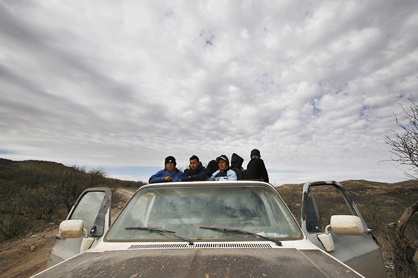 A group of migrants get ready to walk through the desert toward the U.S. border, near the city of Sasabe, Mexico. (Photo by Alexandre Meneghini/AP)