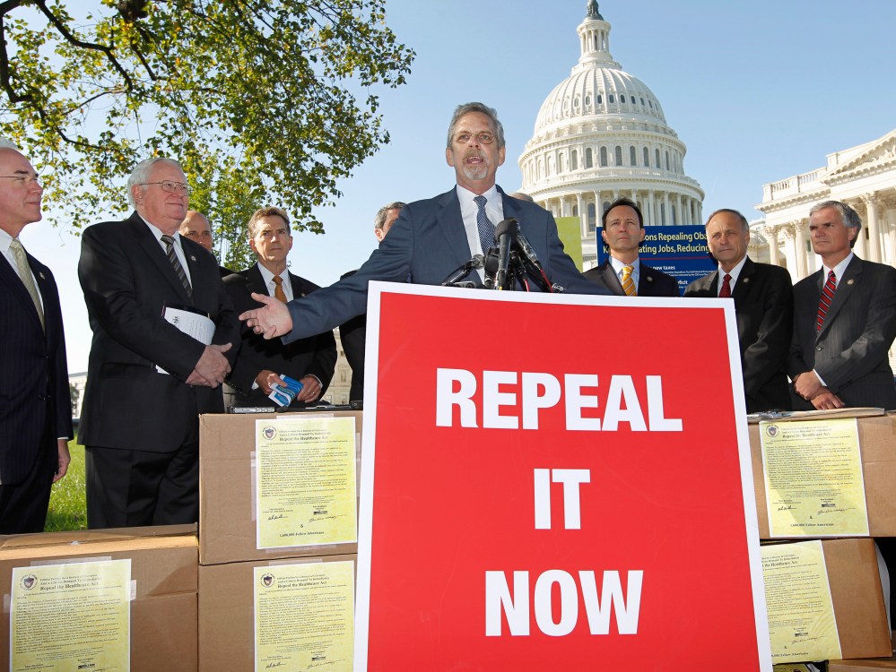 File Photo: Flanked by conservative lawmakers, Ken Hoagland, chairman of the Repeal It Now.org campaign, center, criticizes President Obama's national heath care plan, often called "Obamacare," Wednesday, Oct. 5, 2011, during a news conference on...