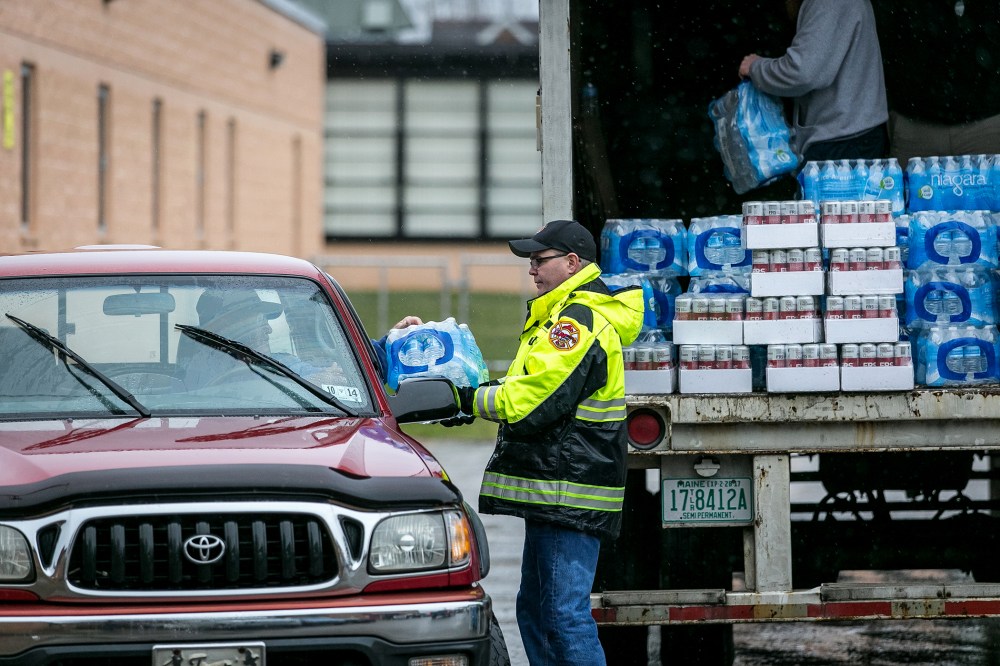Members of the Nitro Volunteer Fire Department distribute water to local residents following the chemical spill, Jan. 10, 2014 in Charleston, W.V.