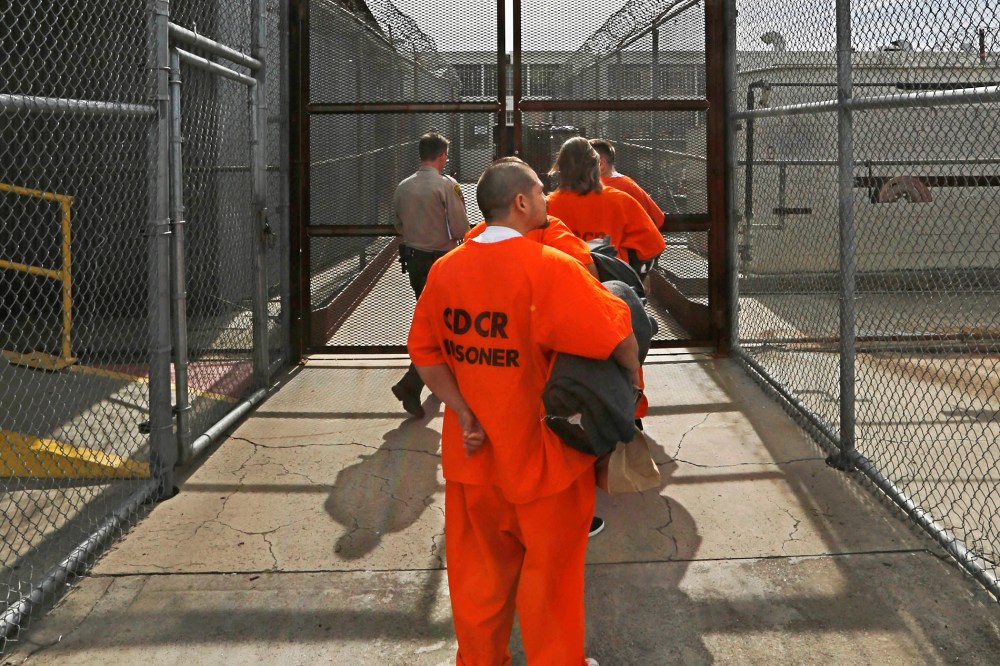 New arrivals to the Deuel Vocational Institution are taken inside the prison near Tracy, Calif., Feb. 20, 2014.