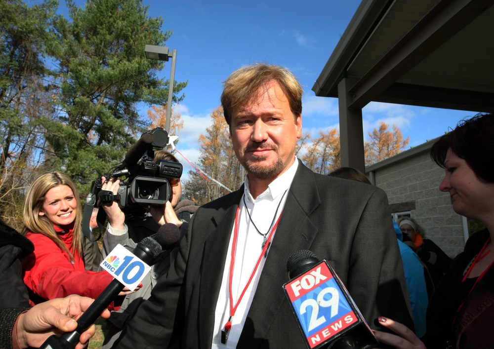 The Rev. Frank Schaefer, center, of Lebanon Pa., is surrounded by the media as he exits the gymnasium for a lunch break from a penalty hearing, at Camp Innabah, a United Methodist retreat, in Spring City Pa., Nov. 19, 2013.