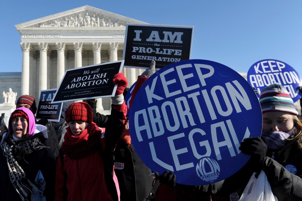 Pro-abortion and anti-abortion protestors rally outside the Supreme Court in Washington, D.C., Jan. 22, 2014.