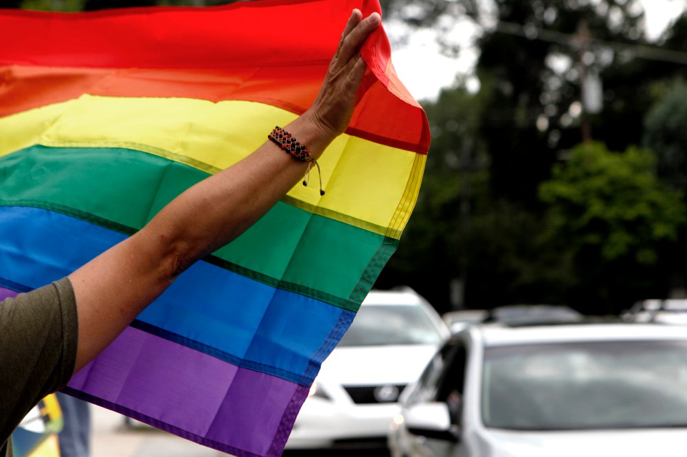 Atlanta resident River Moore holds up a rainbow flag while celebrating of the U.S. Supreme Court's rulings same-sex marriage on June 26, 2013, in Atlanta, Ga.