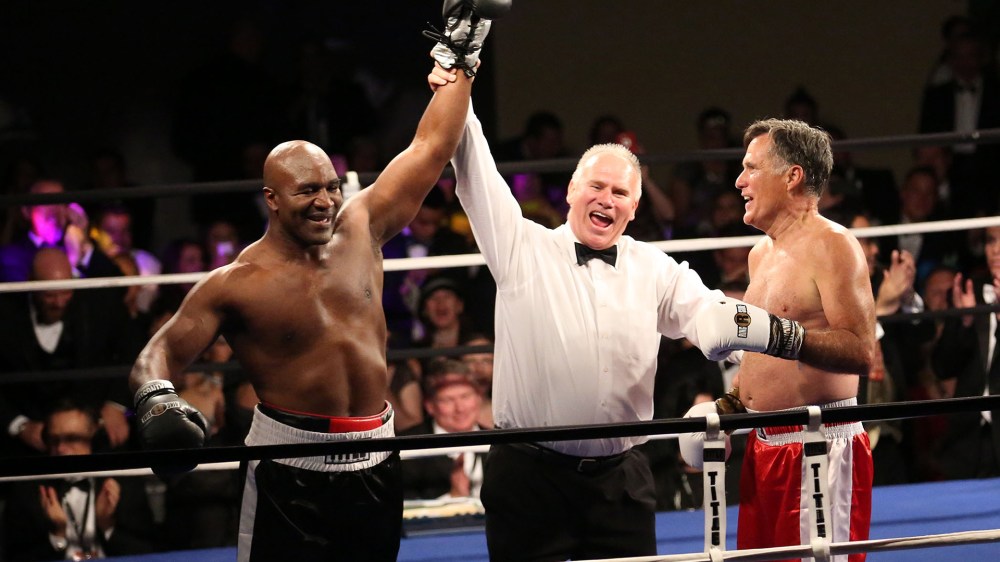 Boxing champion Evander Holyfield is declared the winner against Former Republican presidential candidate Mitt Romney during a charity fight night event on May 15, 2015, in Salt Lake City, Ut. (Photo by Kristin Murphy/Deseret News via AP)