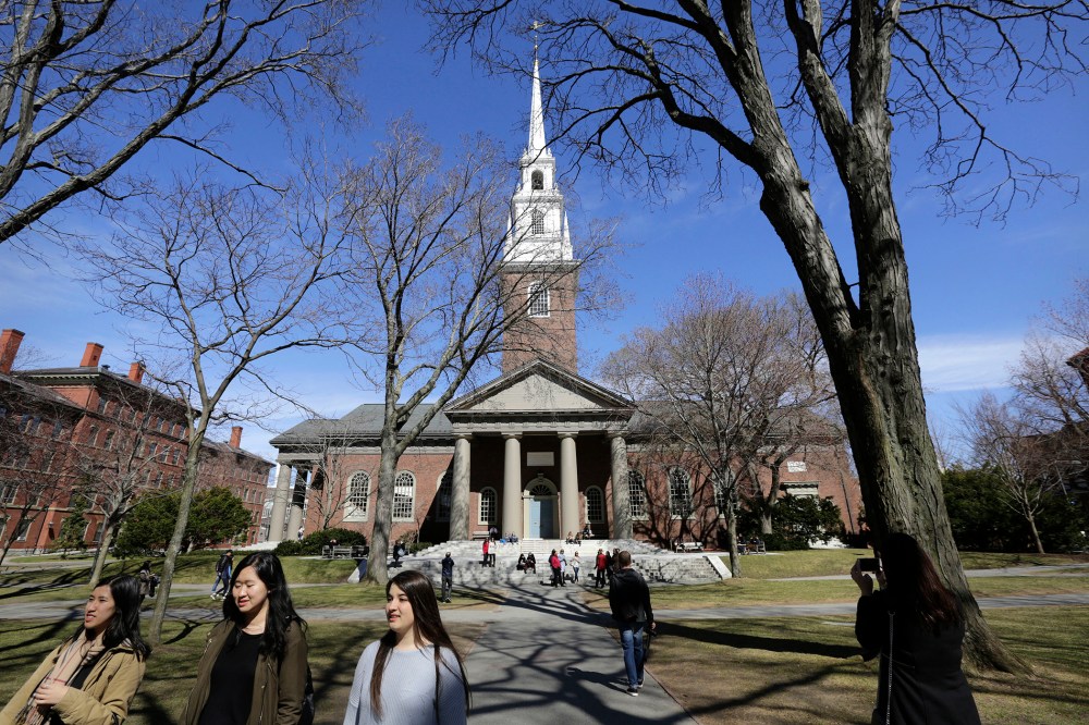People walk near Memorial Church on the campus of Harvard University, in Cambridge, Mass., March 13, 2016. (Photo by Steven Senne/AP)