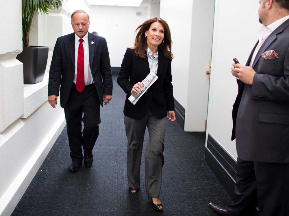 Rep. Steve King and Rep. Michele Bachmann leave a House Republican conference meeting on Capitol Hill on Saturday, Oct. 12, 2013 in Washington.