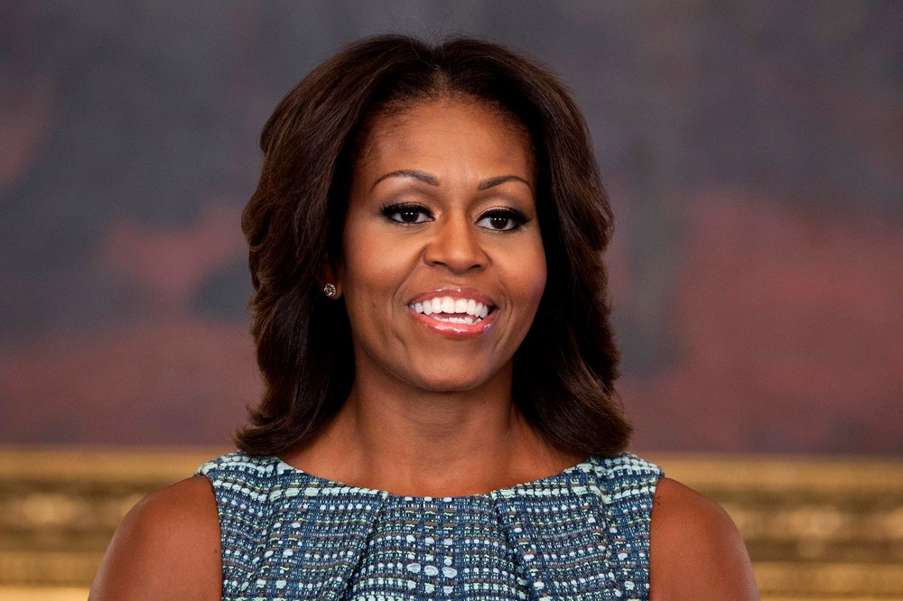 First lady Michelle Obama pauses during an event in the State Dining Room of the White House on Sept. 18, 2013, in Washington, D.C. (Photo by Evan Vucci/AP)