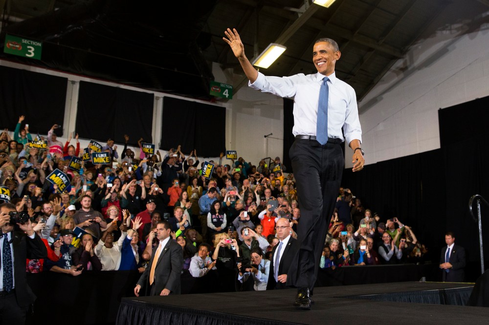 President Barack Obama waves after being introduced during an event on Oct. 30, 2014, in Portland, Maine. (Photo by Evan Vucci/AP)