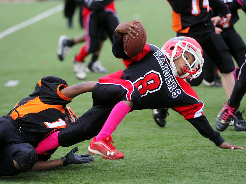 Eastern York County's Isaiah Jones, 8, brings down Zamir Weedon-Parker, 8, in the second half of the rink varsity semifinal game at Central York High School on Oct. 28, 2012. Football had the highest concussion rate, according to the “Game Changers”...