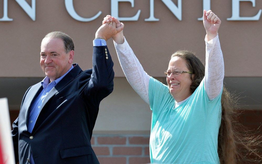 Rowan County Clerk Kim Davis, with Republican presidential candidate Mike Huckabee at her side, greets the crowd after being released from the Carter County Detention Center, Sep. 8, 2015, in Grayson, Ky. (Photo by Timothy D. Easley/AP)