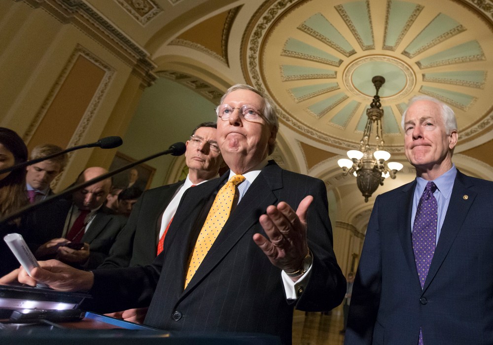 Senate Majority Leader Mitch McConnell, flanked by Sen. John Barrasso, R-Wyo., and Majority Whip John Cornyn, R-Texas, talks to reporters following a closed-door meeting at the Capitol in Washington, March 15, 2016. (Photo by J. Scott Applewhite/AP)