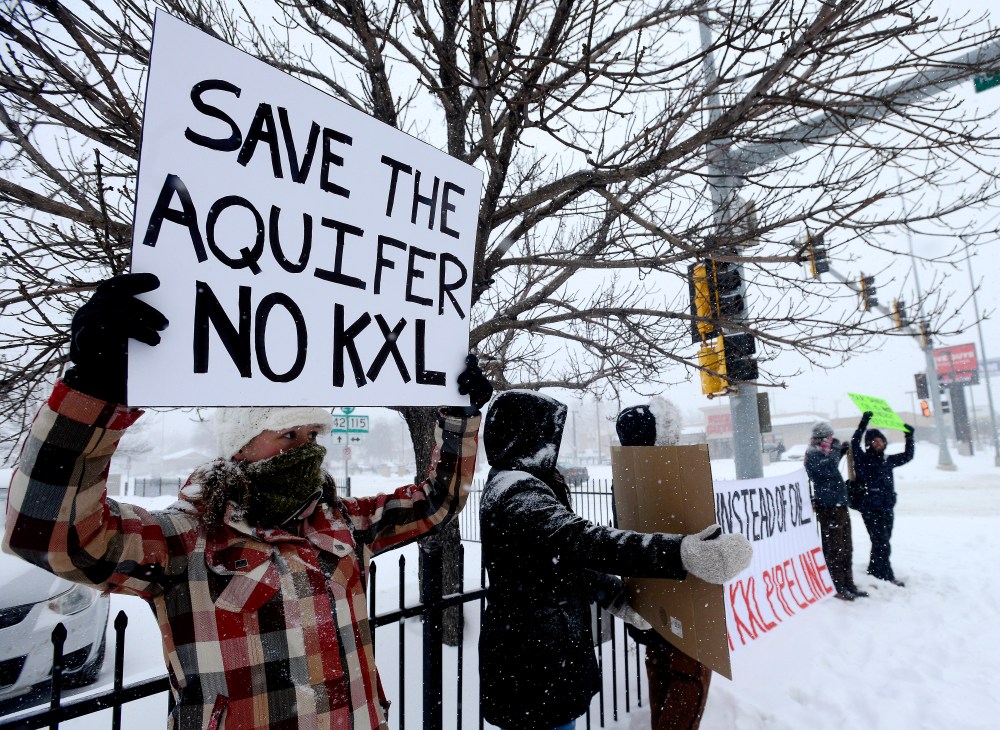 Valerie Schonewill and several others protest the proposed Keystone XL pipeline, Jan. 5, 2015, in Sioux Falls, S.D. (AP Photo/Argus Leader, Elisha Page)