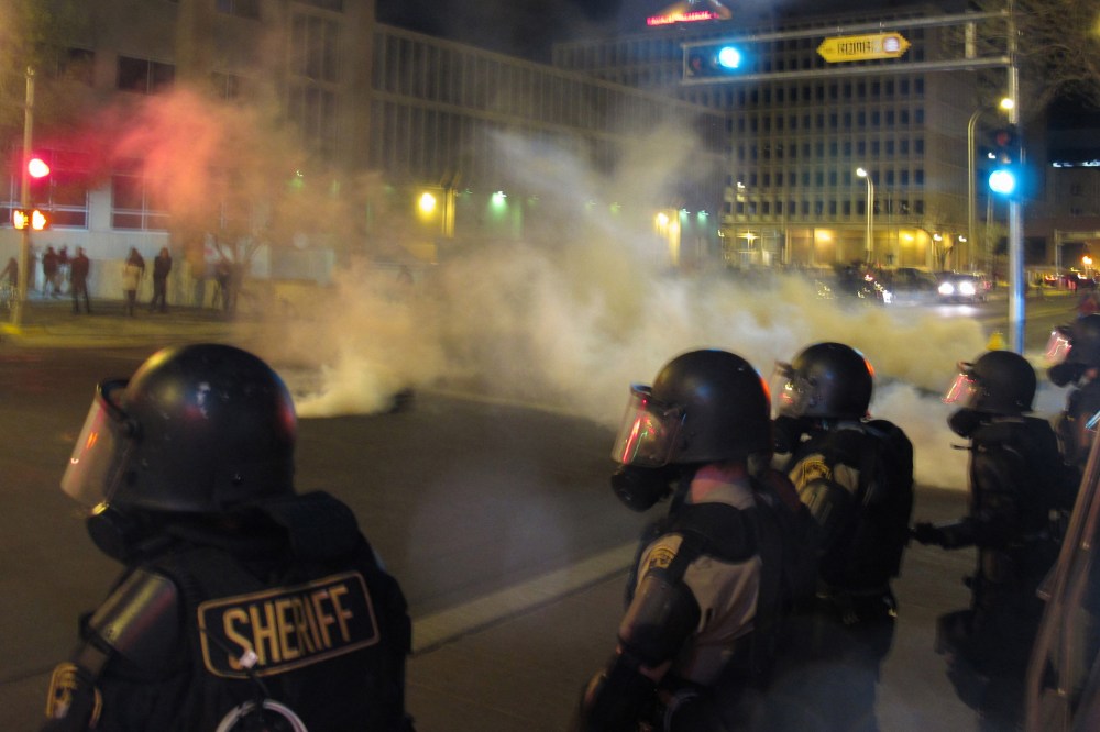 Riot police launch tear gas toward activists in downtown Albuquerque, N.M. following a 10-hour protest around the city, on March 30, 2014.
