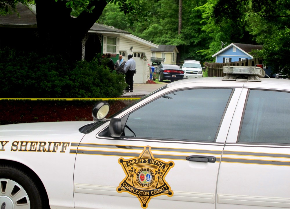 Investigators work at a scene of a shooting in Hollywood, S.C., May 7, 2015. A sheriff's deputy responding to a home invasion shot the homeowner in the neck Thursday because he refused to drop his gun, authorities said. (Photo by Bruce Smith/AP)