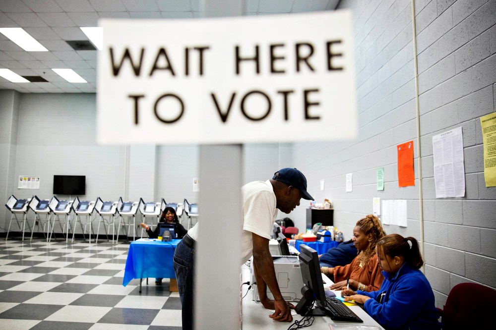 Charles Poole, 70, checks in upon arriving to cast his ballot at a polling site during early voting in Atlanta, Ga. on May 16, 2014.
