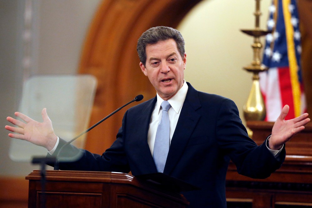 Kansas Gov. Sam Brownback delivers his State of the State speech to an annual joint session of the House and Senate at the Statehouse in Topeka, Kan., Jan. 15, 2014. (Photo by Orlin Wagner/AP)