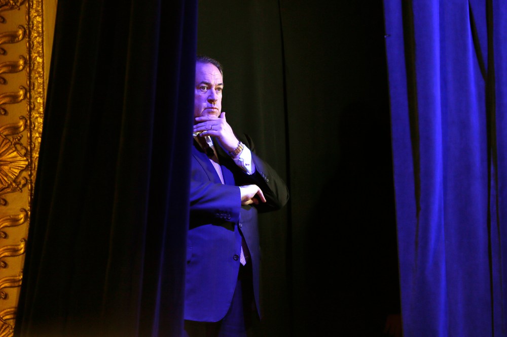 Former Arkansas Gov. Mike Huckabee waits backstage before speaking during the Freedom Summit, Jan. 24, 2015, in Des Moines, Iowa. (Photo by Charlie Neibergall/AP)