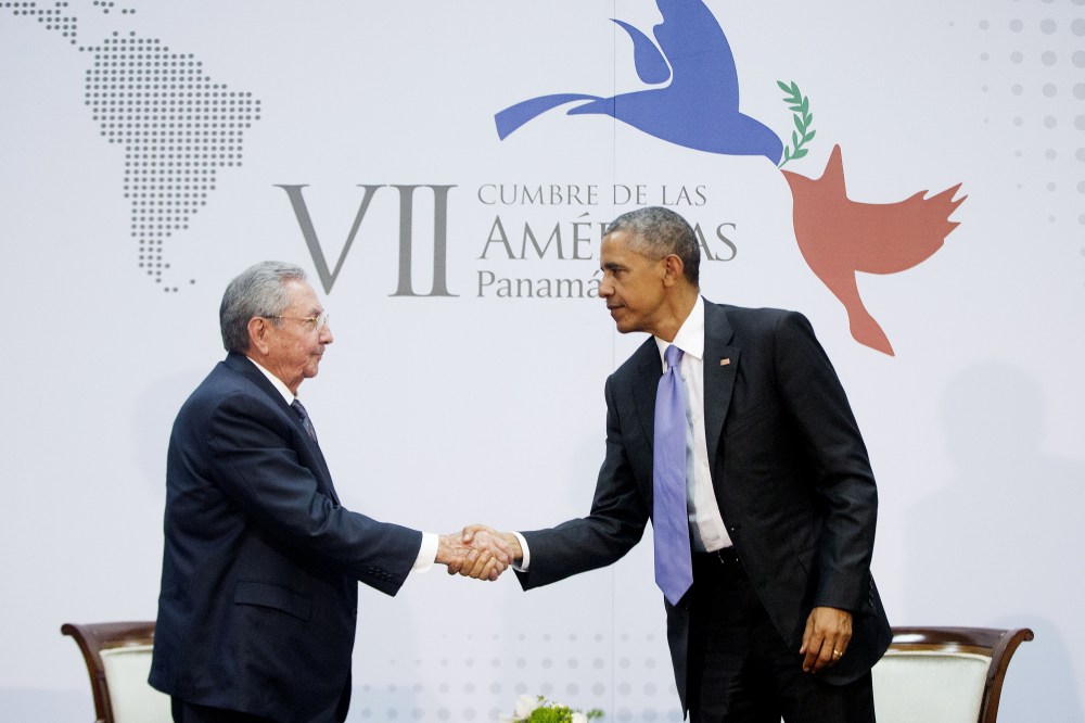 US President Barack Obama and Cuban President Raul Castro shake hands at the Summit of the Americas in Panama City, Panama, Saturday, April 11, 2015. (Photo by Pablo Martinez Monsivais/AP)