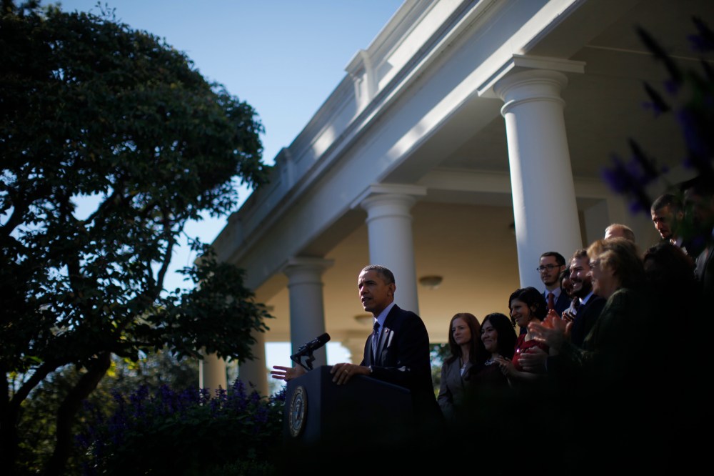 President Barack Obama stands with supporters of his health care law during an event in the Rose Garden of the White House