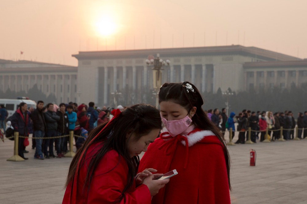 A Chinese woman wears a mask as she visits Tiananmen Square in Beijing, China, Dec. 19, 2015. (Photo by Ng Han Guan/AP)