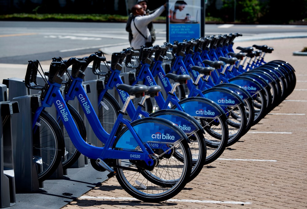 Bicycles, part of the NYC Bike Share program, are lined up at a dock and lock station at the Brooklyn Navy Yards Sunday, May 12, 2013 in New York. The expanding bike share system allows those who join to ride bicycles and return them from the same or...