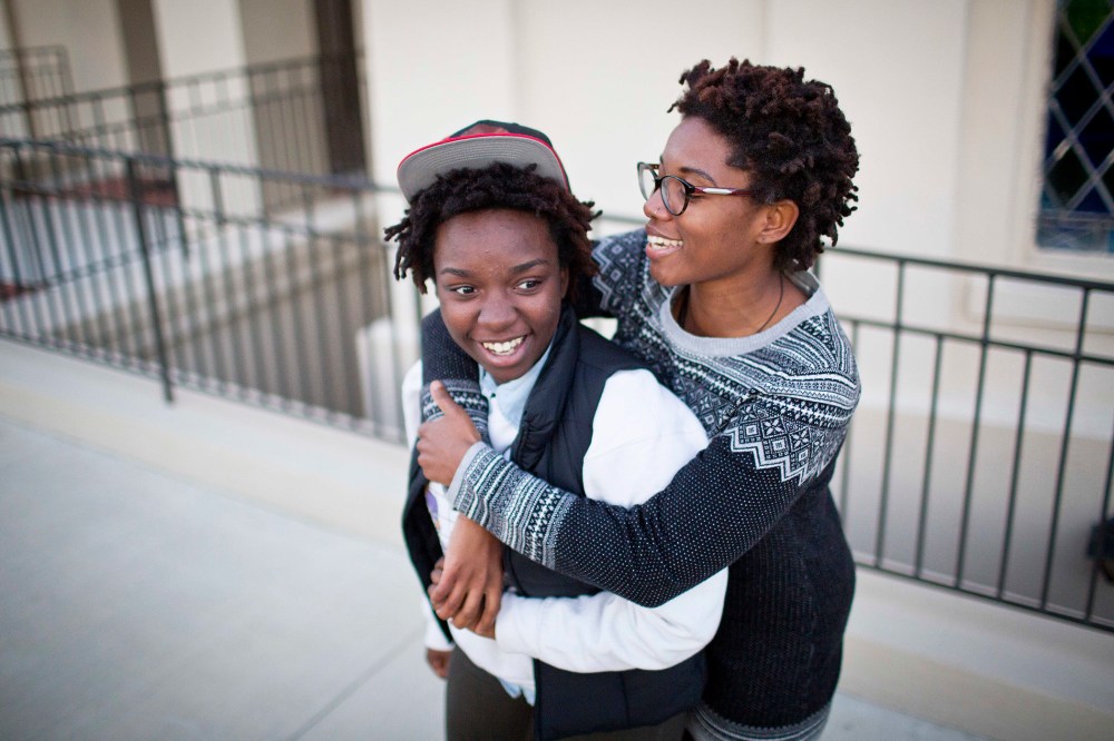 Shanté Wolfe, left and Tori Sisson embrace near the Montgomery County Courthouse, Jan. 25, 2015, in Montgomery, Ala., where they plan to stay overnight to be married Monday morning. (Photo by Brynn Anderson/AP)