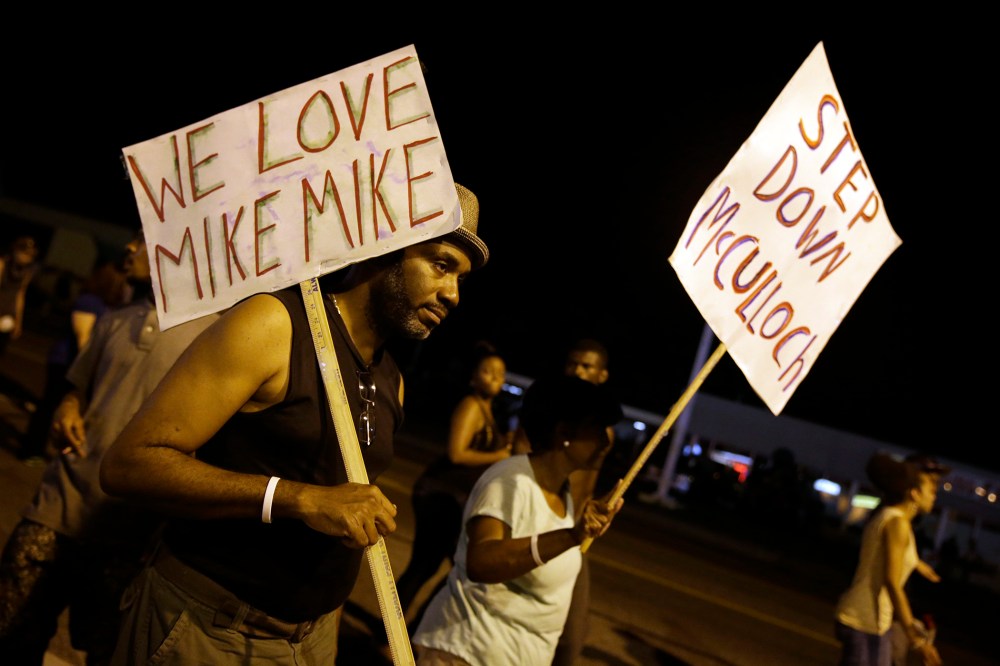 Protesters march Thursday, Aug. 21, 2014, in Ferguson, Mo.
