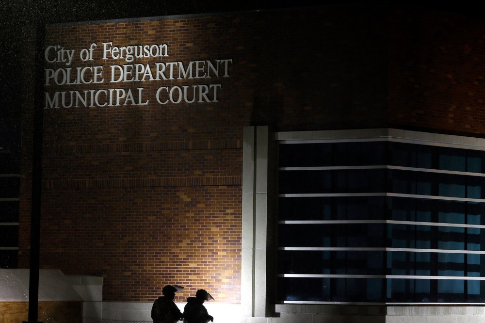 Members of Missouri National Guard stand outside of the Ferguson Police Department and the Municipal Court in Ferguson, Mo. on Nov. 26, 2014. (Photo by Jeff Roberson/AP)