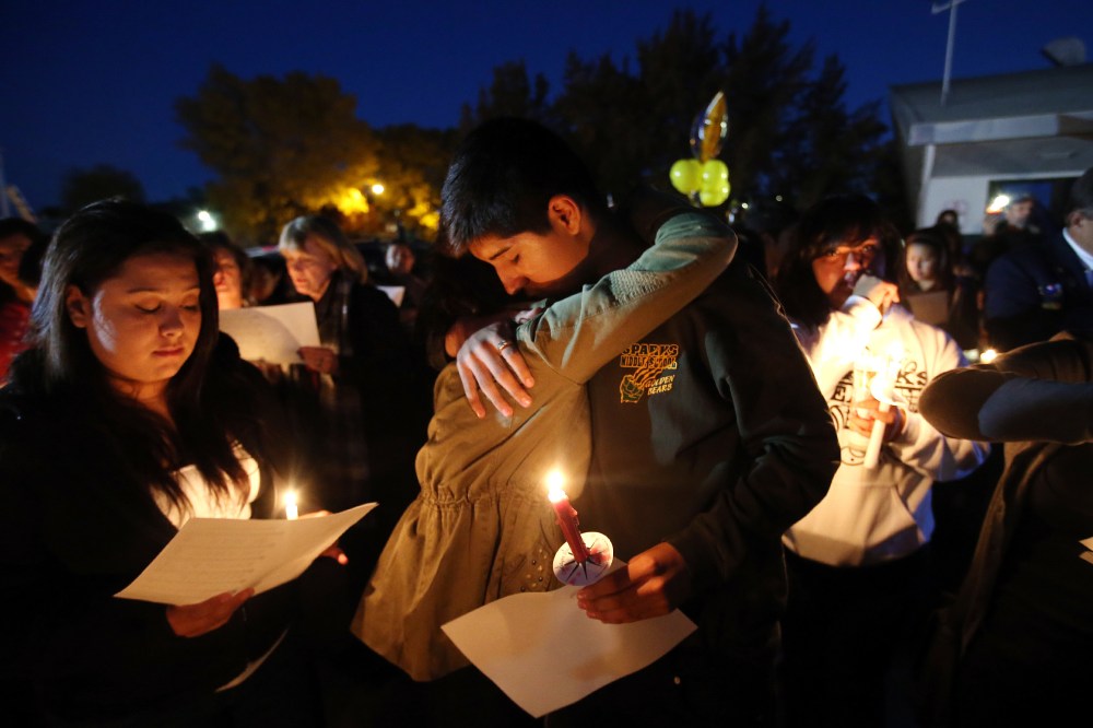 Hundreds of students and residents attend a candlelight vigil at Sparks Middle School in Sparks, Nev., on Wednesday, Oct. 23, 2013,