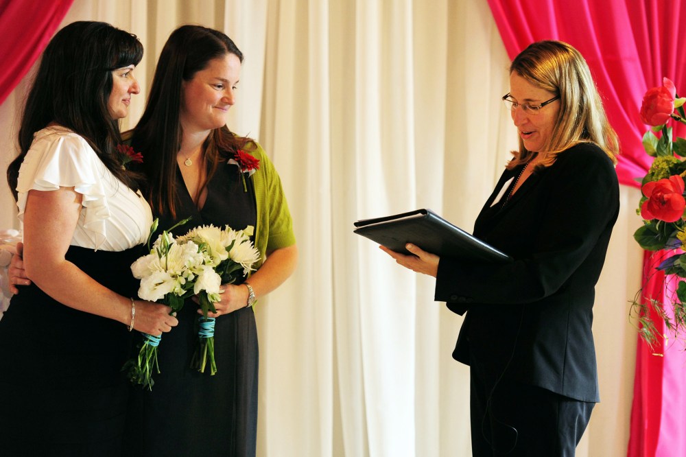 Julia Fraser, left, and Jessica Rohrbacher get married in Portland, Ore., May 19, 2014.