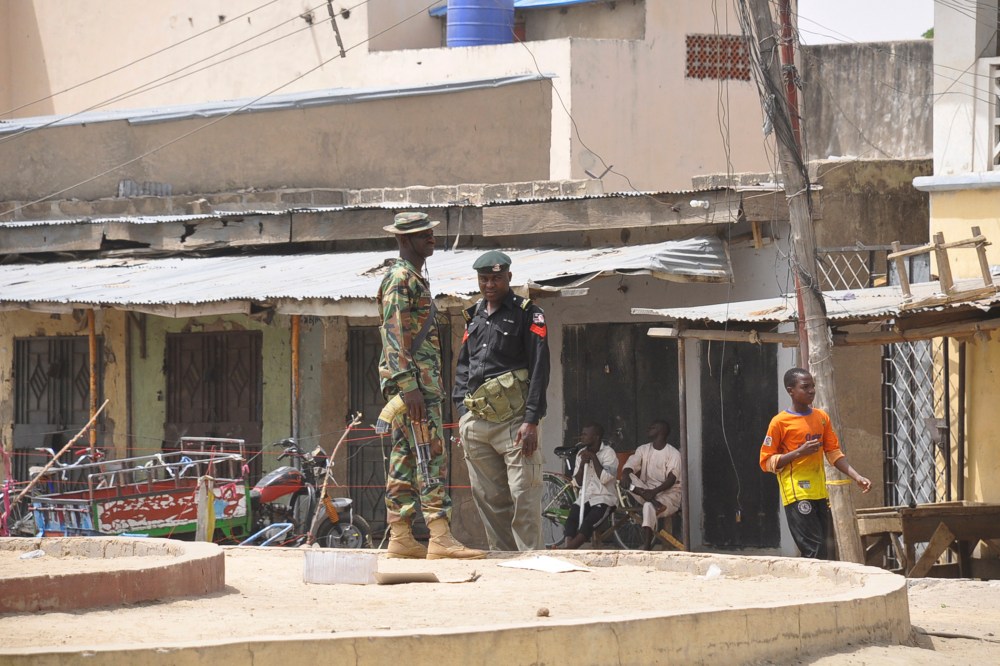 Security forces stand guard at the site of bomb explosion at a market in Maiduguri, Nigeria on March 7, 2015. (Photo by Jossy Ola/AP)