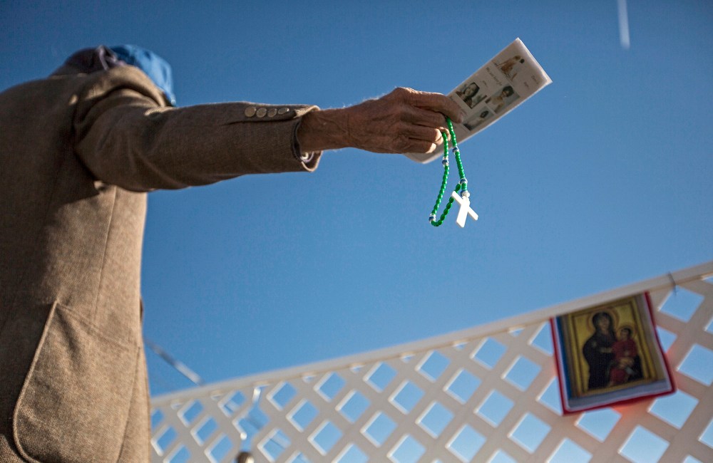 A protester waves anti-abortion literature in the direction of a reproductive health clinic on Nov. 14, 2013, in Albuquerque, N.M.