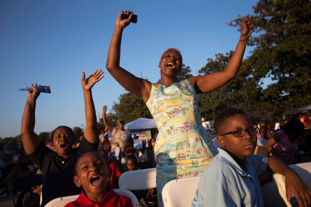 Priscilla Smith, left, and Sabrina Mobley, both of Decatur, Ga., dance before U.S. Senate candidate Michelle Nunn takes the stage, on Oct. 27, 2014, during a Democratic rally encouraging early voting in Decatur, Ga.