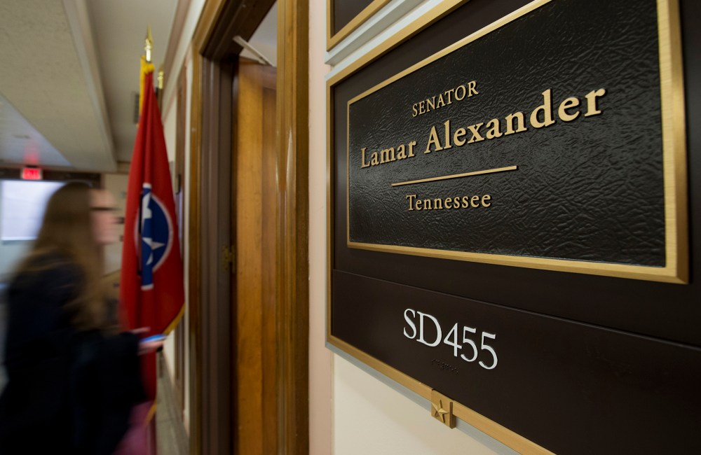 A person walks near the office of Sen. Lamar Alexander, R-Tenn. on Capitol Hill in Washington, Wednesday, Dec. 11, 2013.