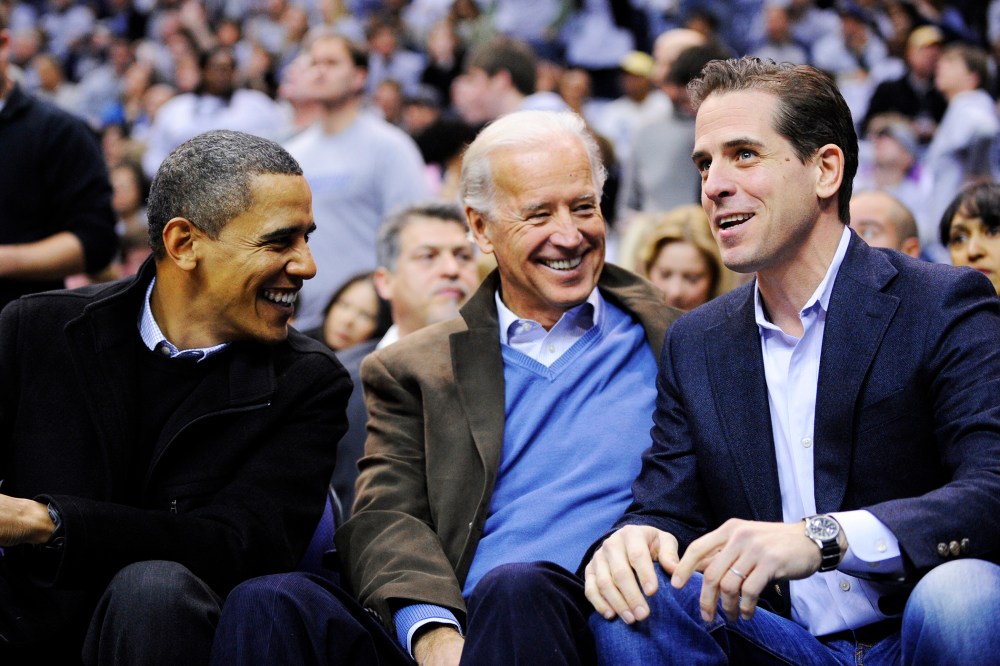 Hunter Biden, right, son of Vice President Joe Biden, center, talking with President Barack Obama during a college basketball game in Washington, D.C. on Jan. 30, 2010.