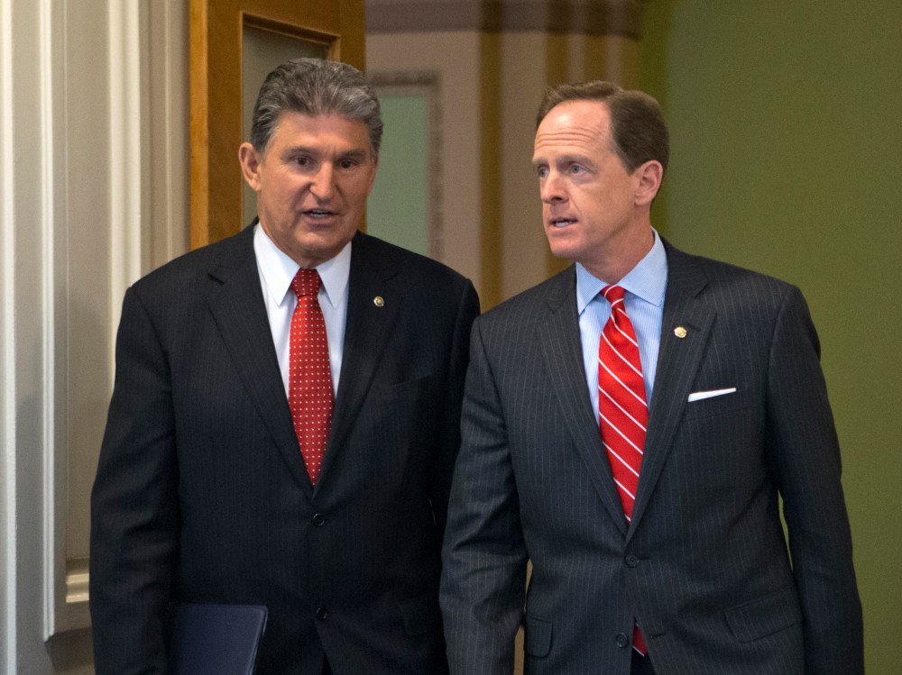 Sen. Joe Manchin of West Virginia, D-W.Va., left, and Sen. Patrick Toomey, R-Pa., arrive at a news conference on Capitol Hill in Washington, Wednesday, April 10, 2013, to announce that they have reached a bipartisan deal on expanding background checks...