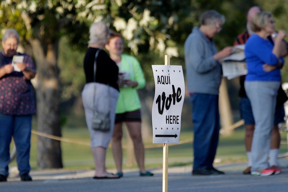 Voters stand in line to vote at an early voting polling site on Oct. 20, 2014, in San Antonio, Texas.