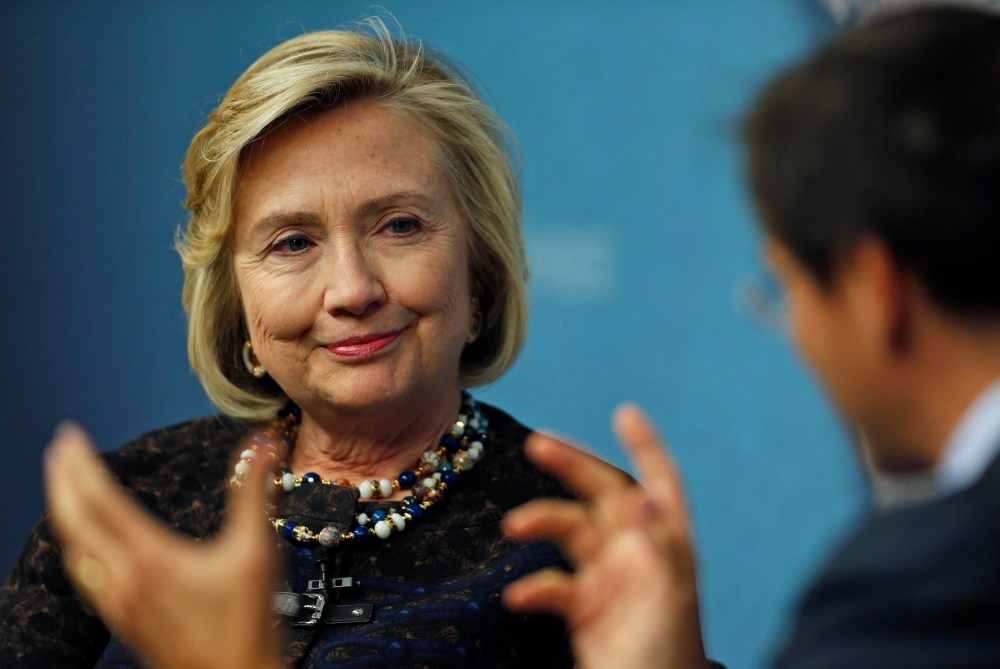 Former U.S. Secretary of State Hillary Clinton, left, listens to Robin Niblett, right, Director of Chatham House, during an event in London, Friday, Oct. 11, 2013.