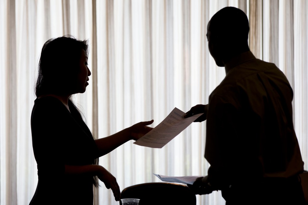 Recruiter Christina O takes an applicants resume during a job fair in Philadelphia, June 23, 2014.