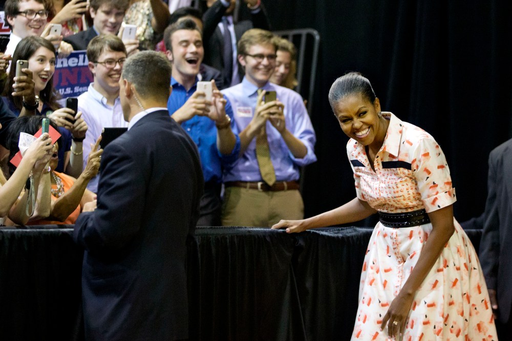 First lady Michelle Obama steps out from backstage as she's introduced by Democratic U.S. Senate candidate Michelle Nunn at a voter registration rally on Sept. 8, 2014, in Atlanta.  (David Goldman/AP)