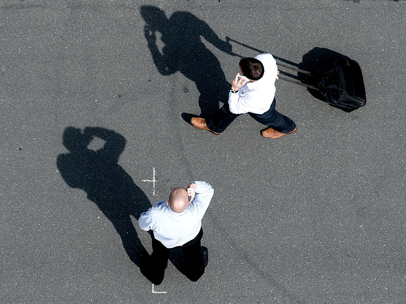 Two men make phone calls ontheir mobile phones at the exhibition grounds in Hanover, Germany, 08 May 2013. (Photo by Julian Stratenschulte/picture-alliance/DPA/AP)