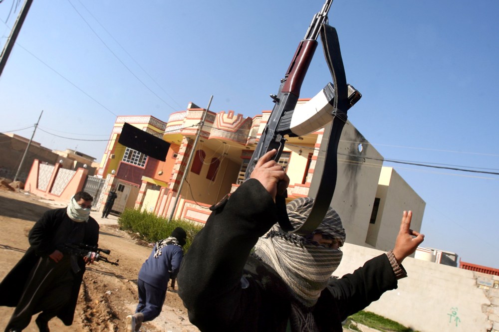 Gunmen patrol in Fallujah Iraq, Thursday, Jan. 9, 2014.
