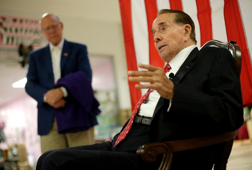 Republican Sen. Pat Roberts listens while former Senate Majority Leader Bob Dole, right, speaks during a campaign stop at a mall in Dodge City, Kan, Monday, Sept. 22, 2014.