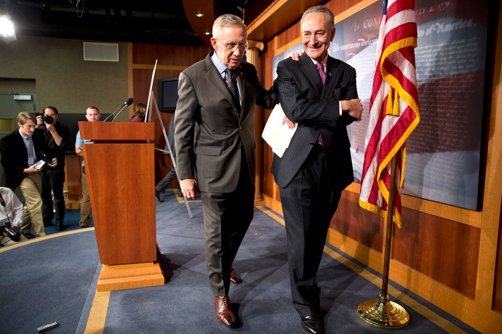 Senate Majority Leader Harry Reid of D-Nev., left, and Sen. Charles Schumer, D-N.Y., leave a news conference on Capitol Hill in Washington on Nov. 21, 2013.