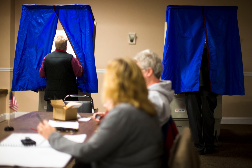 A voter steps into voting booth, Nov. 5, 2013, in Philadelphia, Pa.